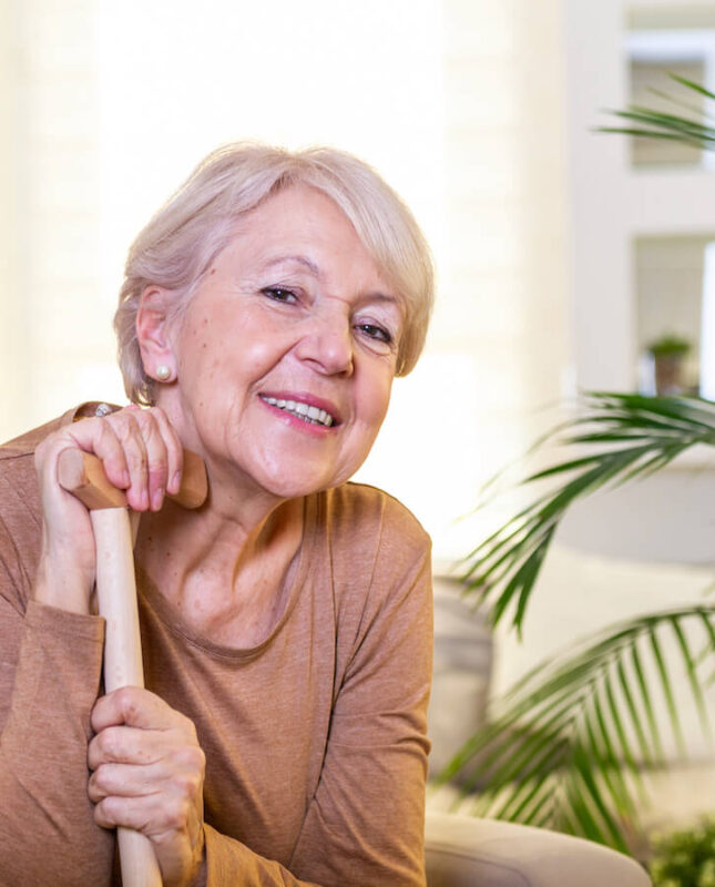 Assisted Living Community woman smiling with cane
