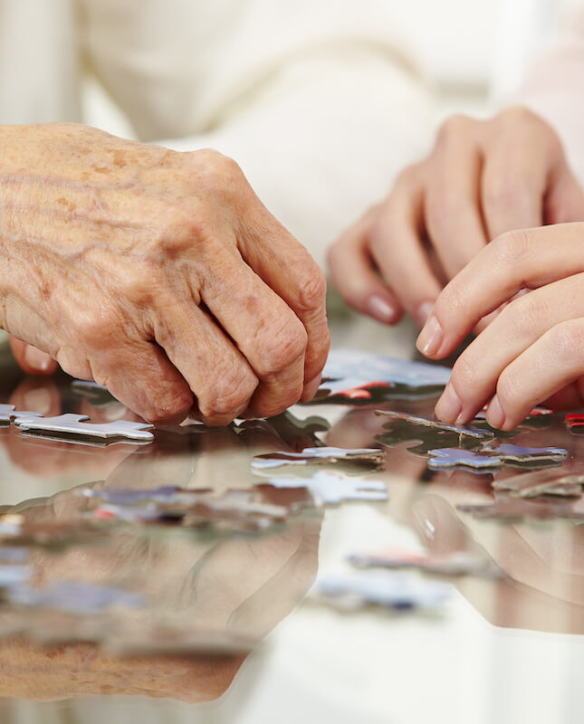 Memory care community doing puzzle